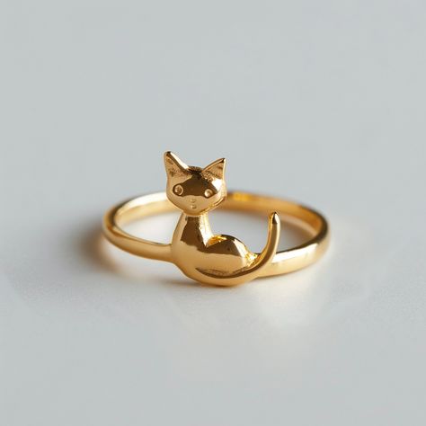 Embrace your love for feline elegance with YoPaCat's Cute Minimalist Golden Cat Ring. This charming ring features a sleek golden cat design, complete with a playful tail that wraps gracefully around your finger. Crafted with simplicity and style in mind, this piece is perfect for cat lovers who appreciate understated beauty. Whether you're dressing up for a special occasion or adding a touch... Gold Cat Ring, Cat Rings, Ring Daily Wear, Golden Cat, Cat Ring, Cat Design, Feline, Cat Lovers, Daily Wear