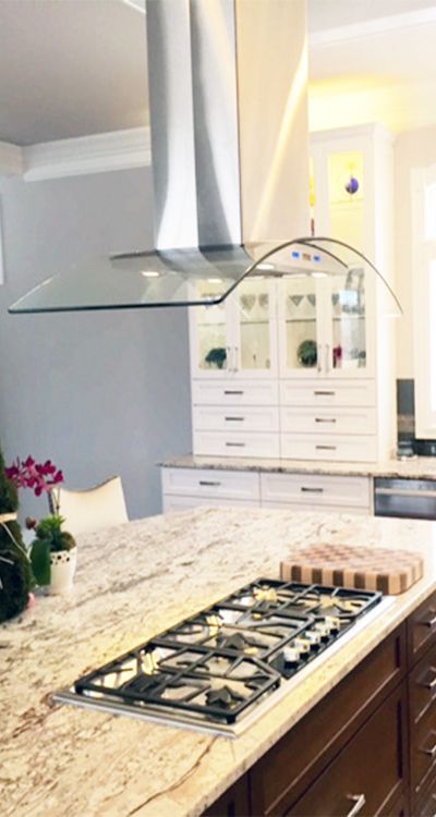 This Curved Glass Stainless Steel Range Hood looks beautiful over this Kitchen Island. PLFW 544 Vent Hood from Proline Range Hoods. View our Range Hood Selection: | prolinerangehoods.com Kitchen Island Range Hood, Island Range Hoods, Kitchen Island Range, Kitchen Island With Cooktop, Island With Stove, Kitchen Island With Stove, Kitchen Vent Hood, Steel Range Hood, Island Range