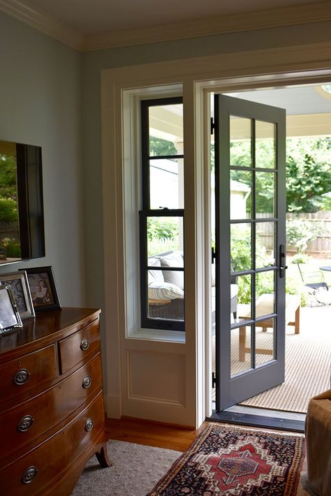 Two skinny double-hung windows on either side of the patio door allow light and style into the space. Multiple French Doors On Front Of House, Bedroom Door To Outside Patio, Narrow Patio Doors, Payio Doors, Sliding Glass Door Front Of House, Sliding Glass Doors Patio Master Bedrooms, French Doors From Bedroom To Patio, Single Exterior Patio Door, Glass Exterior Door In Kitchen