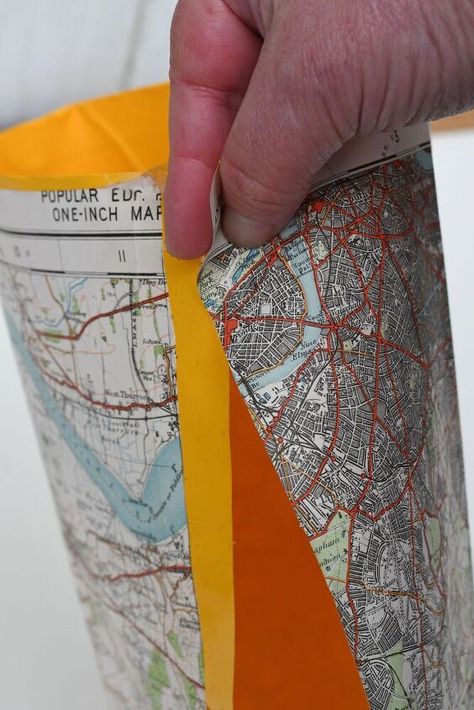 I love old road maps and have a stash of them at home that I keep for crafting. They are cheap craft paper, that can really add interest to a project. One of the most popular map crafts on my post is my pretty map roses.This time I decided to make some fun map buckets that I used as plant pot covers. They only took 10 mins to make and are waterproof as well as looking funky. For this craft, you will need an old road map and some contact paper. I think contact paper in a nice brigh… Paper Plant Pots, Diy Plant Pot, Plastic Bottle Planter, Luminaries Bags, Map Bag, Road Maps, Planter Bags, Map Crafts, Plant Pot Diy