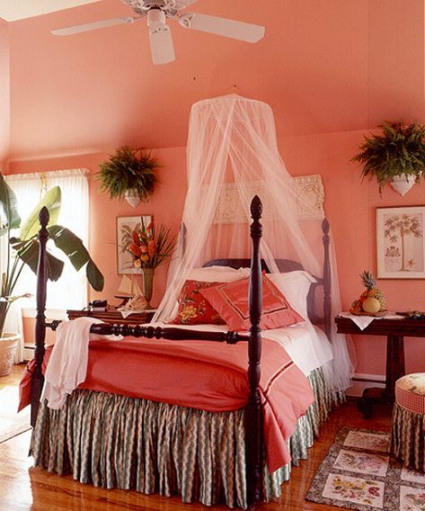 The coral-hued bedroom is reminiscent of a Caribbean bungalow — complete with mosquito netting and exotic flowers.  - GoodHousekeeping.com Caribbean Interior Design, Nice Bedrooms, Painting Rooms, Peach Bedroom, Coral Room, Colour Pallettes, Coral Bedroom, Gimme Shelter, Tropical Bedrooms