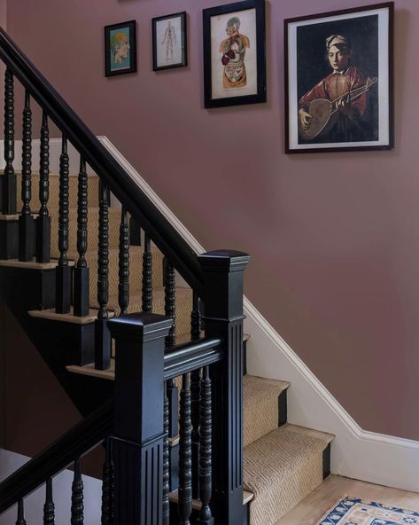 Moody and gorgeous in every light, the star of this space at our Chase Street Project is @farrowandball paint in Sulking Room Pink. Build: Design : @milkandhoneygroup Photo: @jessicadelaneyphotography #designer #design #gc #generalcontractor #newton #massachusetts #chasestreet #project #charming #staircase #victorian #milkandhoneygroup Victorian House Staircase, Sulking Room Pink Hallway, 1930s Staircase, Colored Staircase, Moody Staircase, Victorian Staircase Ideas, Staircase Victorian, Moody Hallway, Charming Staircase