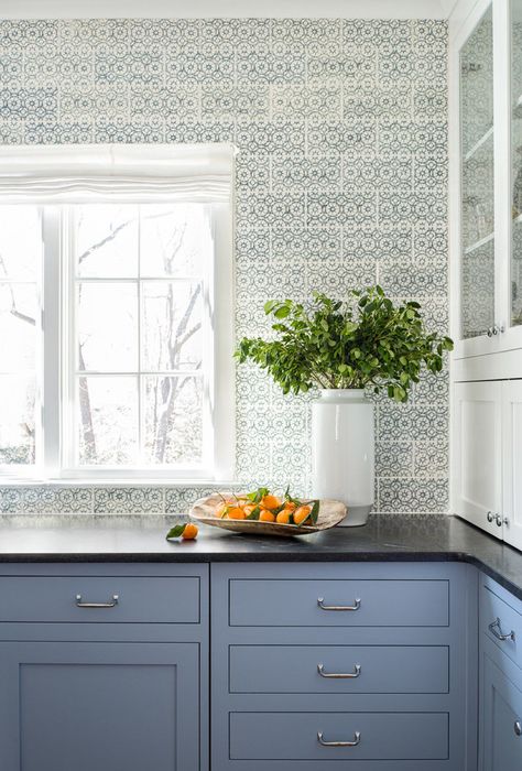 Kitchen with blue cabinetry and blue, bubbly wallpaper, paired with black granite countertops. Blue Kitchen Wallpaper, Kitchen Black Granite, Light Blue Kitchen, Black Granite Kitchen, Black Kitchen Countertops, Light Blue Kitchens, Black Granite Countertops, Black Countertops, Blue Kitchen Cabinets