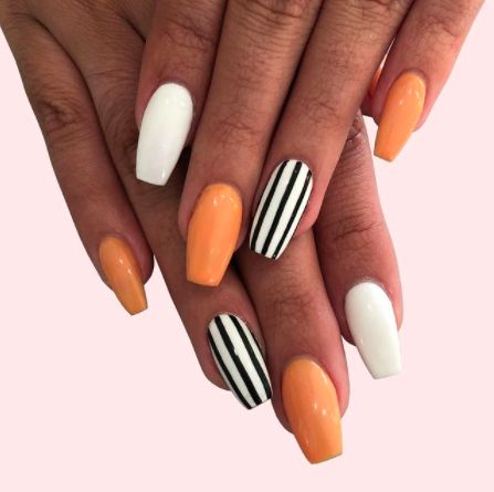 Orange Nails: Beetlejuice Stripes. Alternating orange and white nails with black striped accents. Click through for 26 orange nail ideas. #orangenailideas #orangenails #nailideas IG: @thecosmostudio Halloween Nails Diy, Holloween Nails, Halloween Acrylic Nails, Cute Halloween Nails, Fall Acrylic Nails, Cute Gel Nails, Nails 2021, Nails Fall, Short Acrylic Nails Designs