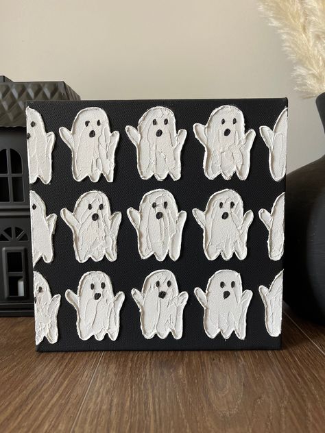 "This textured ghost painting is sure to add spirit and spookiness to your Halloween home decor! Would be perfect as a Halloween gift for a friend or coworker or for yourself!  Beautiful white textured ghosts on a black background.  Made with a mix of high quality acrylic paints and acrylic mediums for a beautiful 3D effect. Handmade with palette knives.  8 inch by 8 inch stretched gallery wrapped canvas and coated with UV resistant varnish for protection.  Would be beautiful in a small space or as shelf decor.  Each piece is unique and cannot be replicated, making this truly a \"one of a kind\" painting. *IMPORTANT: Colors and lighting may vary slightly in photographs. Colors and lighting of the original piece may also vary slightly depending on the natural lighting in the room.* ~Each ar Ghost Plaster Art, Ghost Texture Art, Easy Canvas Art Fall, Ghost Wall Decor, Fall Halloween Decor Diy, Fall/halloween Decor Ideas, Fall Decoration Crafts, Fall Textured Painting, Halloween And Fall Decor