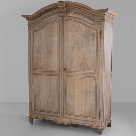 The arched antique carved French wardrobe was crafted in France, circa 1820. Hand-carved border trim accents bring this 2-door wardrobe cabinet to life. A bleached finish on the oak construction enhances its beauty. This eye-catching piece is perfect for your bedroom. #french, #antique, #armoire Antique French Bedroom, Kitchen Armoire, French Country Armoire, Wooden Armoire, Creating A Capsule Wardrobe, Armoire Makeover, Vintage Armoire, Elegant Outdoor Furniture, Mirrored Armoire