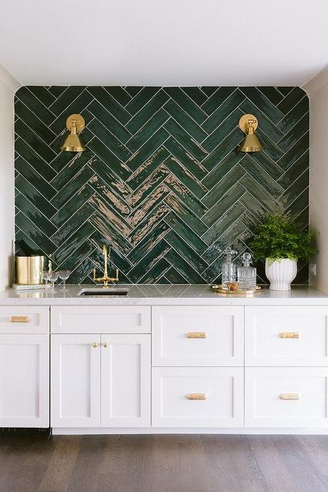 Contemporary white wet bar accented with glossy green herringbone backsplash tiles and white and gray quartzite countertops boasting an antique brass vintage bar faucet. White Wet Bar, Green Tile Backsplash, Herringbone Tile Backsplash, Kitchen With White Cabinets, Green Backsplash, Herringbone Backsplash, Ideas Hogar, Club Ideas, Contemporary Dining Room