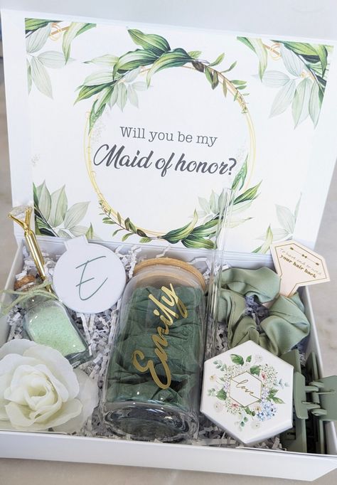 First and foremost CONGRATULATIONS on your engagement! YOU said yes and now you need HER to say yes! This box is full of things made just for her so she knows how special she is to you! Box contents 💎YOUR CHOICE of a personalized 16 oz glass coffee tumbler with bamboo lid and glass straw or 6 oz stainless steel champagne tumbler  💎Personalized Magnetic box   💎Bath salts in glass jar with cork screw lid  💎 Personalized compact mirror  💎Personalized acrylic keychain in gift box 💎Cardstock interior card "Will you be my maid of honor?" Or "Will you be my bridesmaid?" 💎Claw clip 💎 Scrunchy "to have and to hold your hair back" 💎Diamond pen 💎Artificial flower 💎Box filler Box dimensions are 10.5x7x3  ⚠️HOW TO ORDER ⚠️ Please enter name, font color, and text choice in personalization. Sage Bridesmaid Proposal Boxes, Would You Be My Maid Of Honor, Sage Green Bridesmaid Proposal Boxes, Will You Be My Maid Of Honor Box Ideas, Maid Of Honor Box Proposal, Will You Be My Maid Of Honor Ideas, Maid Of Honor Box Ideas, Will You Be My Bridesmaid Ideas, Bridal Proposal Box Ideas