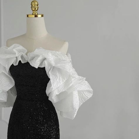 This gothic black and white wedding dress is sure to stand out from the rest. It is adorned with sequins and a ruffle that cascades down the front. The fit is flattering for all body types and the dress is sure to make a statement. ❤️CUSTOM MADE❤️ For custom made, please message us your height, bicep circumstance, bust, lower chest circumference, mid-shoulder to bust point, waist and shoulder width. How to measure? Black And White Evening Gown, Black And White Wedding Dress, Black And White Prom Dresses, White Evening Gown, Masquerade Outfit, Plus Size Formal Dress, Black And White Gown, White Evening Gowns, White Ball Gowns