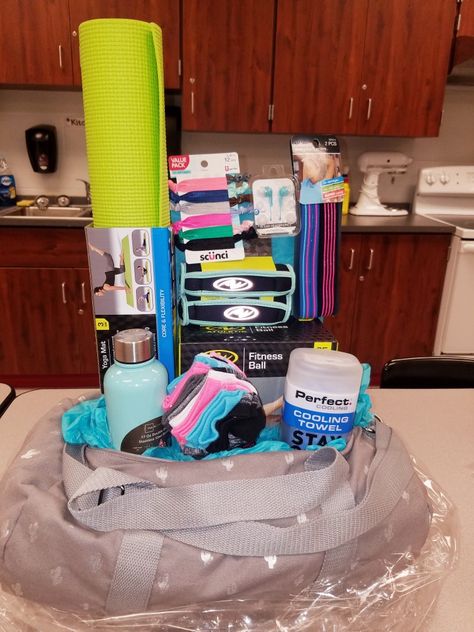 Fitness raffle or gift basket Sports Themed Raffle Baskets, Healthy Raffle Basket Ideas, Duffel Bag Gift Basket, Runners Basket Gift, Fitness Raffle Basket Ideas, Health And Fitness Gift Basket Ideas, Track Gift Basket, Yoga Gift Basket Ideas, Women Raffle Basket Ideas