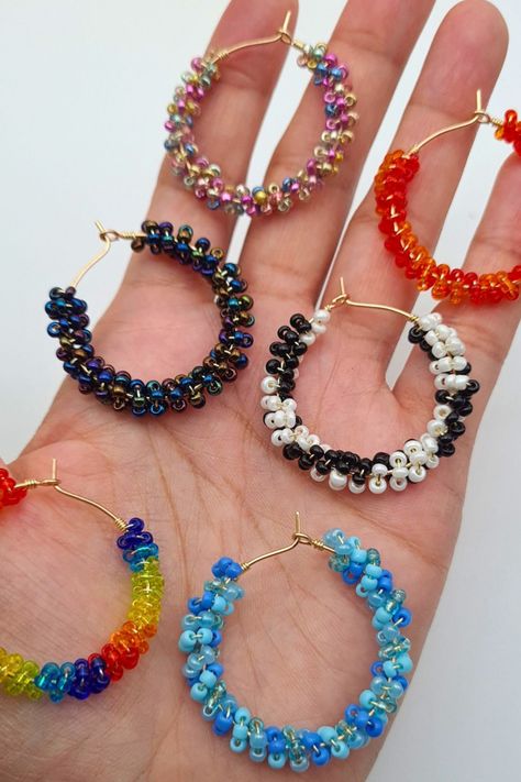 Seed bead hoop earrings in a variety of colours. Minimalist yet stylish to go with any outfit. They can be worn with everyday outfits or can be given as a gift to a loved one. The hoops are gold plated and approx. 3cm in length. There are 6 different colour options available: Rainbow Multi-coloured, Blue Mix, Black & White, Red & Orange, Dark Metallic & Multi-coloured Metallic. Seed Bead Hoop Earrings, Bead Hoop Earrings, Earrings Gold Hoop, Beaded Earrings Diy, Earrings Diy, Beaded Hoop Earrings, Beaded Hoops, Seed Bead Earrings, Beads Bracelet