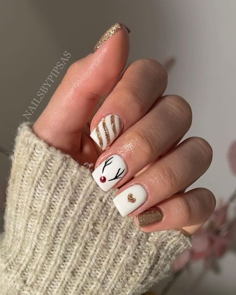 17 Festive Christmas Nail Designs for 2023 - thepinkgoose.com Reigndeer Nails, Reindeer On Nails, Christmas Nails Acrylic Reindeer, Christmas Nails Rain Deer Simple, Reindeer Nails Short, Christmas Nail Designs Reindeer, Reindeer Acrylic Nails, Reindeer Nails Christmas, Christmas Nails Rain Deer