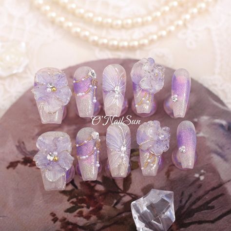 "A purple dress, eating grapes, lilacs - I love purple." - Angela Yee. Default shape: Medium Coffin Welcome to O'NailSun, where we will bring your nail art dreams to life! Our press-on nails are made with love and top-quality materials such as gel polish, gel nails, shiny gel, gel topcoat, and more. We offer custom sizing options for our nails. Just drop us a message, and we will make sure your nails fit perfectly! Our exquisite press-on nails sets are reusable, and you can remove them easily wi Quince Nails Purple And Gold, Wedding Nails Lilac, Purple 3d Nails, Purple Nails With Gems, Purple Flowers Nails, Purple Nails Butterfly, Nails Junk, Wedding Bridal Nails, Chloe Adams