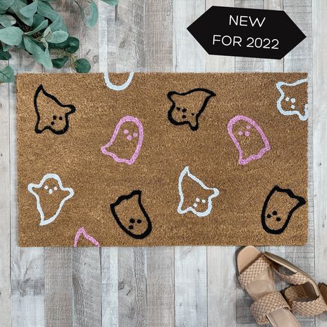 "Our special edition pink 'Ghosts Galore' doormat is the perfect way to create a spooky Halloween themed entry way for all of your  guests! Our welcome mats are each hand-painted and made just for you! Available in 3 sizes: Standard, 18x30 inches, Half Round 24x36 inches and Oversized, 24x36 inches 🍂Production time is 5-7 business days prior to shipping. Shipping is UPS Ground service. 🍂This listing is for the hand painted doormat only, you can pair our doormat with our buffalo check rug avail Diy Spooky Mat, Spooky Welcome Mat, Spooky Doormat Diy, Halloween Rugs Ideas, Halloween Rug Painting Ideas, Ghost Door Mat, Diy Halloween Mat, How To Make Door Mats, Halloween Doormat Ideas