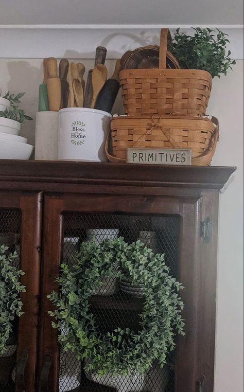 French Country Above Cabinet Decor, Rustic Basket Decor, Baskets On Top Of Cabinets, Country Antique Decor, Decorating With Wicker Baskets, Baskets On Top Of Hutch, Decorating Top Of Hutch Farmhouse, Longaberger Basket Ideas Display, Baskets On Top Of Fridge