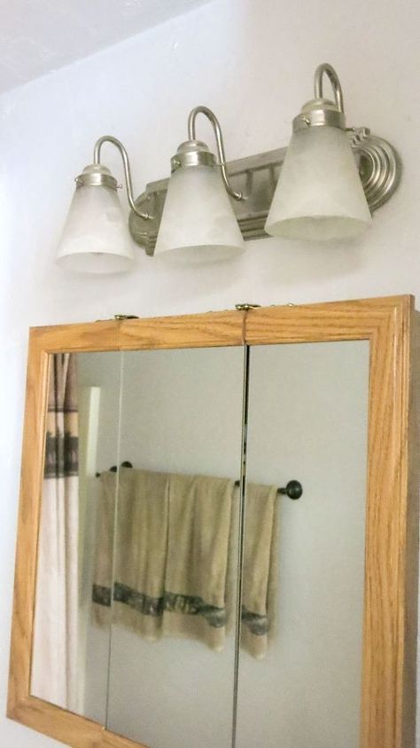 The hottest way to update your boring bathroom light is here! Spray Painting Light Fixtures, Rustic Bathroom Light Fixtures, Diy Vanity Lights, Light Fixture Makeover, Farmhouse Bathroom Light, Glass Light Globes, Painting Light Fixtures, Vanity Light Shade, Rustic Bathroom Lighting