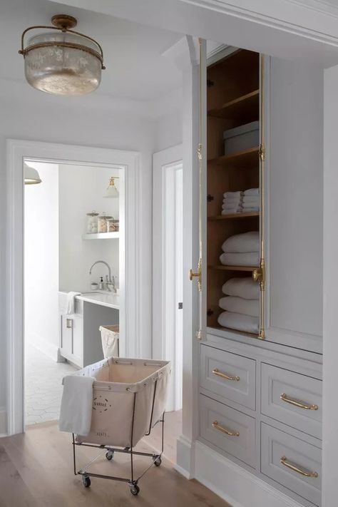 24 Laundry Room Cabinet Ideas for a Pretty, Clutter-Free Space Transitional Laundry Room, Grey Floating Shelves, Laundry Cabinet, Grey Laundry Rooms, Patterned Tile Backsplash, Light Gray Cabinets, Grey Shelves, White Subway Tile Backsplash, Linen Cabinets