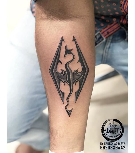 skyrim dragon tattoos...game which you'll never be bored of..Tattoo by Ganesh Acharya..To book an appointment contact-9620339442 #tattoo #tattoos #tattoodesign #inkblot #inkblottattoos #bangalore #bangaloretattoos #besttattoos #tattoostudio #skyrim #skyrimtattoos #dragon #dragontattoos #forearmtattoos #crazytattoos Skyrim Logo Tattoo, Skyrim Dragon Tattoo, Morningstar Tattoo, First Tattoo Ideas For Men, Forearm Tattoo For Men, Httyd Tattoo, Arcane Tattoo, Skyrim Tattoo, Forearm Tattoo Designs