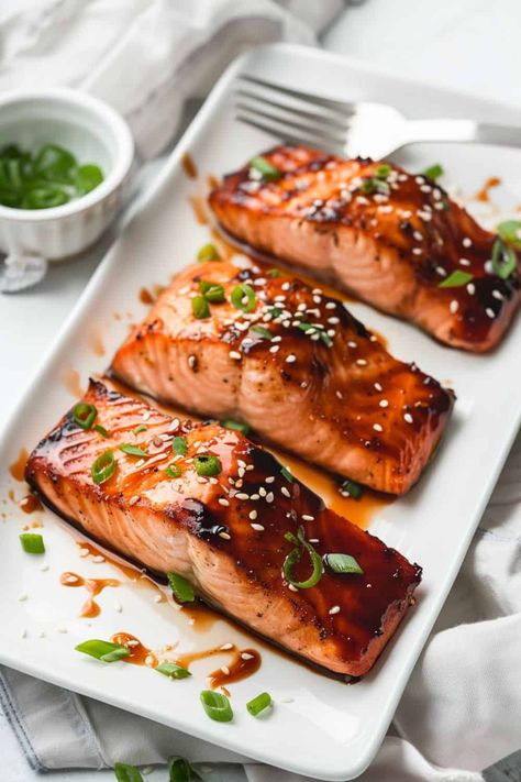 Three fillets of Teriyaki Salmon, beautifully seared with a golden exterior, glazed in a sweet and savory teriyaki sauce, making it a go-to recipe for a fast and flavorful dinner. Salmon Recipes Baked Teriyaki, Teriyaki Fish Recipes, Teriyaki Salmon Recipes, Terriyaki Salmon, Salmon With Teriyaki Sauce, Teriyaki Fish, Grilled Teriyaki Salmon, Salmon Teriyaki, Salmon Teriyaki Recipe