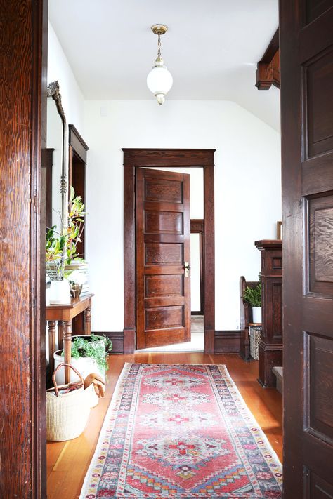 how to buy and care for vintage rugs // the Grit and Polish Dark Wood Chair Rail, White Room With Colored Trim, White Walls Dark Brown Trim, Natural Wood Trim Living Room, Dark Stained Trim Interior, Modern With Antique Decor, Painted Door Trim, Wood Floors With Wood Trim, White Walls With Dark Trim