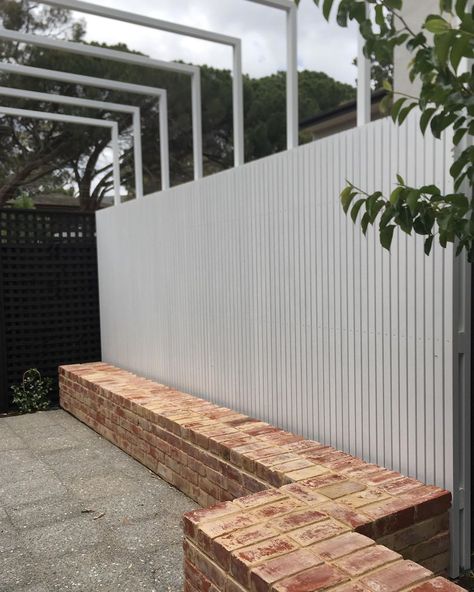 David Baptiste Garden Design on Instagram: “Recycled brick bench seat, slatted timber privacy screen and light steel pergola opens up the space in this courtyard garden - Burnside…” Brick Benches Diy Outdoor Seating, Brick Garden Design, Brick Bench Seat, Built In Garden Bench Seating, Brick Seating Outdoor, Brick Bench Outdoor, Timber Privacy Screen, Brick Seating, Brick Bench