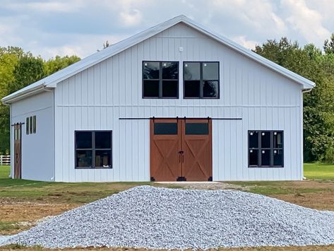 Who says a barn can't be modern? EDCO's Glacier White metal siding makes a beautiful exterior for a modern barn or barndominium. Learn more at edcoproducts.com. White Metal Siding House, White Metal Barndominium, White Metal Building With Black Roof, White Shop House, White Metal Shop With Black Trim, White Metal Siding, Metal Barns Exterior, White Metal Building, White Barndominium With Galvanized Roof