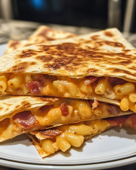 Loaded Bacon Macaroni Quesadilla 🧀🥓 🍽️ Serves: 4 ⏲️ Cooking Time: 30 minutes 🔥 Calories per serving: 600 📝 Ingredients: 2 cups cooked macaroni and cheese 8 large flour tortillas 1 cup cooked and crumbled bacon 1 cup shredded cheddar cheese 1/2 cup shredded mozzarella cheese 1/2 cup sour cream (for serving) 2 tbsp butter, for frying 1/4 cup chopped green onions (optional garnish) 1/4 tsp garlic powder 1/4 tsp paprika Salt and pepper to taste 👩‍🍳 Instructions: Heat a skillet over medium hea... Cheesy Macaroni, Shredded Cheddar Cheese, Daily Recipes, Crumbled Bacon, Flour Tortillas, Shredded Mozzarella, Daily Meals, Mozzarella Cheese, Green Onions