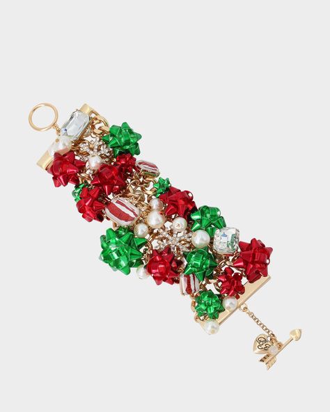 Vibrant statement bracelet featuring festive green and red bows, mixed stone gems, pave snowflakes and lustrous pearls. Bracelet has an easy toggle closure. Made from polished metal, glass, plastic and faux pearls. 7.5" L, 1.75" W Imported Present Bow, Betsey Johnson Clothes, Pearls Bracelet, Fierce Women, Popular Handbags, Betsey Johnson Dresses, Toggle Bracelet, Ice Queen, Betsey Johnson Jewelry