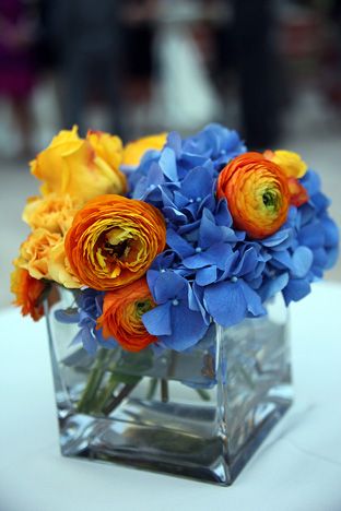 Love these colors Orange And Blue Wedding Table Decor, Orange And Blue Centerpieces, Blue Orange And White Centerpieces, Orange Blue Centerpiece, Blue Orange Yellow Centerpiece, Orange Blue Flower Arrangement, Blue Yellow Orange Flower Arrangements, Sparkle Photography, Blue Orange Weddings