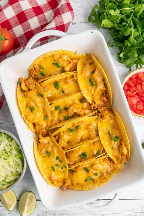 Overhead look at baked chicken tacos in a white dish. Baked Chicken Tacos Oven, Baked Tacos Chicken, Baked Chicken Taco, Baked Chicken Tacos With Corn Tortillas, Slow Cooker Keto Recipes, Baked Chicken Tacos 12 Tomatoes, Shredded Pork Recipes, Baked Chicken Tacos, Slow Cooker Chicken Tacos