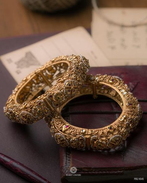 Harit Zaveri Jewellers on Instagram: "Vintage Dream With every glance, the delicate dance of pearls and colored stones on your wrists unfolds a narrative written in 22k gold. Our traditional kadas speak volumes of heritage and craftsmanship. 📍Address: Harit Zaveri Jewellers, Ground Floor, Akshar Complex, Shivranjani, Ahmedabad - 15 📞Contact: +919023724779, +918160400477 22kt Gold | Diamond | Polki Bridal & Dailywear Jewellery Follow 👉 @dailywearhz for Daily Wear Gold & Diamond Jewellery. 🛍️ Experience the Promise of Right Price on every shopping experience at Harit Zaveri Jewellers. . . . #ahmedabadjeweller #ahmedabad #vintagedreams #classicjewellery #bridaljewelery #handcraftedjewellery #handmadeinindia #weddingjewelry #heritagejewelry #designerjewelry #aestheticjewelry #rarejew Harit Zaveri Jewellery, Vintage Gold Jewelry Indian, Indian Heritage Jewellery, Vintage Indian Jewelry, Golden Jewellery, Wedding Jewellery Designs, Bridal Jewelry Sets Brides, Bangle Design, Indian Wedding Jewelry Sets