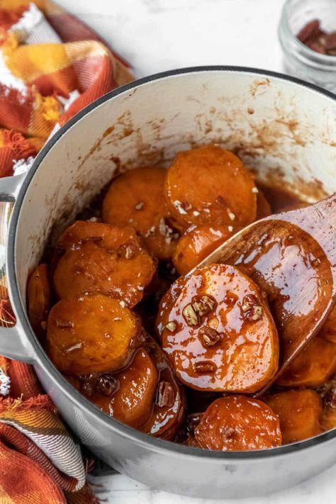 A wooden spatula scooping up a candied sweet potato from a Dutch oven. Sweet Potato Oven, Best Thanksgiving Side Dishes, Candied Sweet Potatoes, Homemade Chocolate Chips, Homemade Dinner Rolls, Potatoe Casserole Recipes, Thanksgiving Meal, Dutch Oven Recipes, Thanksgiving Side