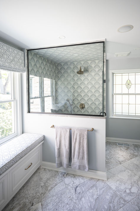 This primary bathroom underwent a huge remodel transforming it from a dated dark space to a bright and welcoming retreat. The showstopper in the room is the intricate mosaic shower tile featuring shades of white, gray and blue. This was used on the walls as well as the floor and ceiling in this luxury steam shower. Michelle then paired a large scale marble tile for the flooring which coordinated perfectly... Luxury Primary Bathroom, Mosaic Shower Tile, Dark Space, Primary Bathroom, Steam Shower, Steam Showers, Marble Tile, Shades Of White, Shower Tile