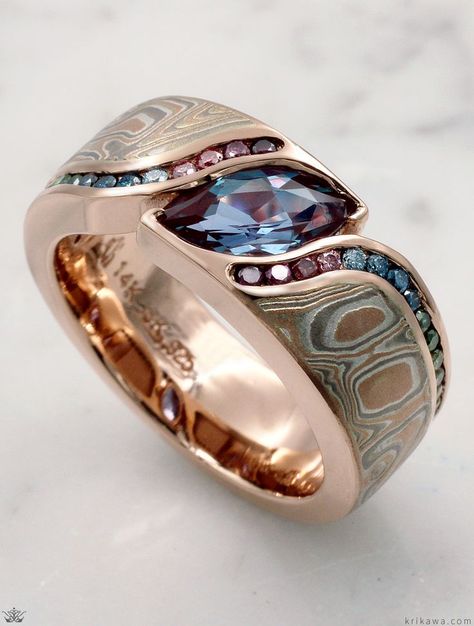 An organically shaped mokume band that is contoured to a variety of stone shapes.  The stone is flush set to the band, which thickens toward the top of the finger to allow for the depth of the stone.  Customized here with two channels of diamonds wrapping around both sides of the stone. The band is handcrafted in 14k rose gold with a 1.20ct Marquise Lab Alexandrite and a rainbow of Vivid Enhanced Color Diamonds. Jewelry Rings Unique, Cool Rings For Men, Stone Shapes, Modern Wedding Rings, Alexandrite Jewelry, Morganite Engagement Ring Set, Alternative Jewelry, Alexandrite Ring, Magical Jewelry