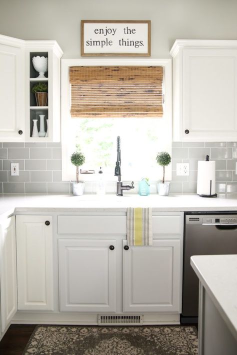 modern farmhouse kitchen with grey subway tile backsplash, white cabinets and bamboo shade on window over sink #newkitchensinkspaces Backsplash Window, Farmhouse Kitchen Window, Gray Subway Tile Backsplash, Kitchen Window Coverings, Above Kitchen Sink, Window Over Sink, Gray Tile Backsplash, Kitchen Sink Window, Gray Tile