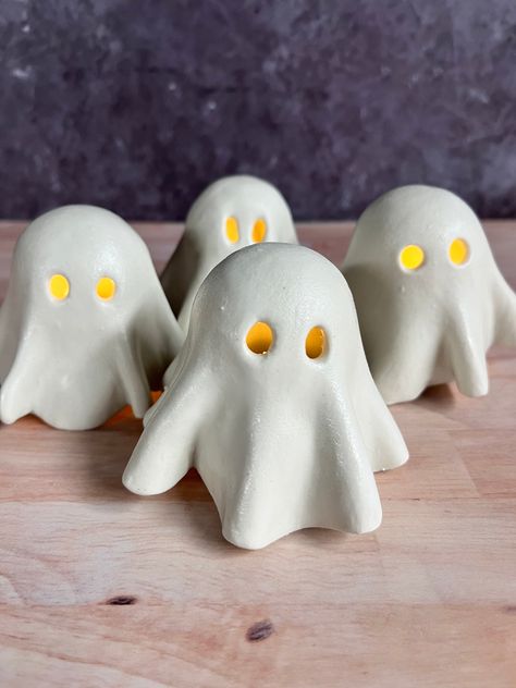 The perfect cute addition to your spooky season decor! These little ghosts are ready to grace your shelves and tables with the flickering light of a tea light candle. Order includes one ghost cover and tea light base. Tea light candles not included. Due to the handmade nature of this item, each ghost is one of a kind. The next round of ghosts is expected to ship by the end of August 2024. Tea Candle Cover, Ghost Tea Lights, Ghost Tea Light Covers, Clay Ghost Tealights, Ceramic Ghost Pottery, Halloween Clay Projects, Air Dry Clay Ghost, Clay Tea Light Holder, Ceramic Ghosts