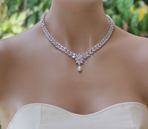 "'Colette' Crystal Bridal Necklace is made with stunning marquise cut and teardrop crystals, and is completed with a starburst of crystals and a Swarovski pearl drop, at center. Colette has the most gorgeous sparkle and will add an elegant and very sophisticated touch to your wedding day jewels. Perfect if you are wearing a strapless dress! The Swarovski pearl droplet can be customized from our extensive pearl collection, for a truly unique bridal accessory. Measures: L = 16\" (40.5 cm) with an Crystal Wedding Necklace, Diamond Necklace Wedding, Silver Bridal Jewellery, Bridal Diamond Necklace, Diamond Necklace Designs, Diamond Necklace Set, Diamond Jewelry Necklace, Necklace Crystal, Bridal Bracelet