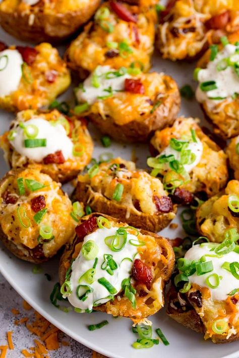 Creamy cheesy fluffy potatoes with crispy bacon - all baked in a crunchy potato skin. These Stuffed Potato Skins are serious comfort food. #potatoskins #stuffedpotatoes #loadedpotatoes #stuffedpotatoskins #gamedayfood #fingerfood Potato Skins Vegetarian, Fluffy Potatoes, Stuffed Potato Skins, Gameday Appetizers, Potato Skins Recipe, Buttery Potatoes, Baked Potato Skins, Potatoe Skins Recipe, Stuffed Potato