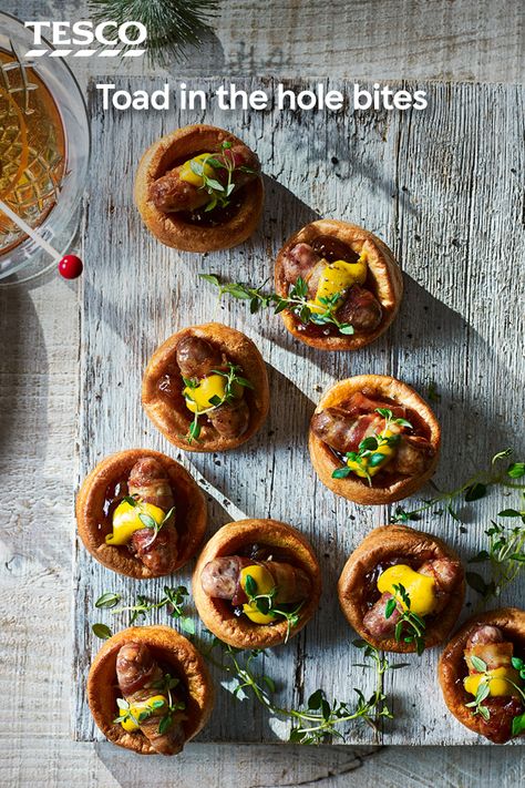 Everyone will love these mini toad-in-the-hole canapés, with fluffy Yorkshire puds and pigs-in-blankets. This easy recipe uses ready-made ingredients, so all you have to do is cook and assemble ready for your Christmas party. | Tesco Savoury Canapes, Winter Platter, Christmas Canapés, Boxing Day Food, Canape Recipes, Pudding Ideas, Christmas Nibbles, Christmas Canapes, Party Nibbles