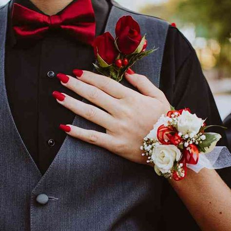 The red rose is the most commonly used symbol for love. If your wedding is filled with red roses, your family and friends with be inhaling love with every breath. #flowers #flowermeanings #symbol #flowersymbols #Floriography #flowerlanguage, #YourTango | Follow us on Pinterest: www.pinterest.com/yourtango Prom Corsage Red, Red Corsages, Prom Flowers Corsage, Wrist Corsage Prom, Prom Corsage And Boutonniere, Boutonnieres Prom, Prom Photoshoot, Prom Date, Corsage And Boutonniere