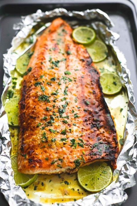 Baked honey cilantro lime salmon in foil is cooked to tender, flaky perfection in just 30 minutes with a flavorful garlic and honey lime glaze. Honey Cilantro Lime Salmon, Cilantro Lime Salmon, Garlic And Honey, Lime Glaze, Fry Fish, Salmon In Foil, Resep Seafood, Lime Salmon, Baked Salmon Recipes