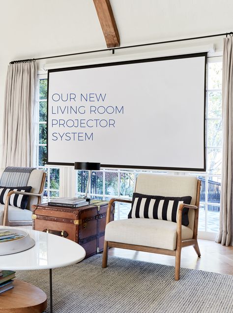 Living room projector system with screen mounted in front of large window Movie Projector Living Room, Tv Solutions Living Room, Projector Screen Living Room, Tv Solutions, Room Projector, Projector Wall, Projection Screen, Motor Homes, Emily Henderson