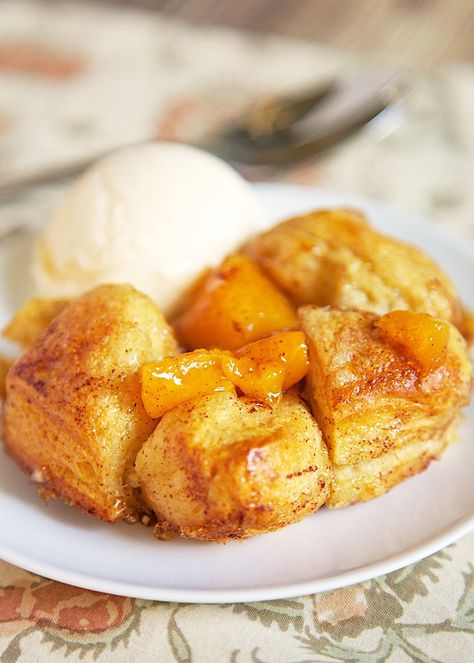 Peach Cobbler Bubble Up recipe. This dessert recipe only has 4 ingredients! It takes about 30 minutes from start to finish. We like to serve this slightly warm with a big scoop of vanilla ice cream! SO good!! Peach Stuff, Peach Paradise, Pillsbury Biscuits, Peach Pie Filling, Canned Biscuits, Peach Desserts, Bubble Up, Peach Cobbler Recipe, Cobbler Recipe