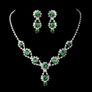 A gorgeous necklace with matching earrings featuring sparkling emerald crystals and clear rhinestones. The rhinestone encrusted silver chain catches the emerald crystals and gracefully drapes each gem with a delicate elegance. It culminates in a subtle pendant hanging with two beautiful emerald crystals.  Size: 13 1/2" (Necklace Length) 1" (Necklace Drop) 1 1/4" (Earrings Length) 1/2" (Earrings Width) Bridesmaid Accessories Ideas, Green Wedding Accessories, Shades Of Green Wedding, Quinceanera Necklace, Emerald Green Jewelry, Winter Wedding Accessories, Green Quinceanera, Quinceanera Jewelry, Emerald Green Necklace