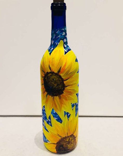 Brighten up your space with this sunflower wine bottle bursting with beauty! Pinot’s Palette is a pioneer of the paint and sip experience – a revolutionary way to enjoy art and wine, meet new people and bond with friends. The more the merrier!! #winebottlepainting #wine #art #paint #wineandpaint #paintparty #paintandsip #winebottleart #pinotspalette Cute Bottle Painting Acrylic, Sunflower Bottle Art, Starry Night Sunflower, Sunflower Bottle Painting, Painted Flowers On Glass Bottles, Sunflower Wine Bottle, Bottle Paint, Pinots Palette, Deco Paint