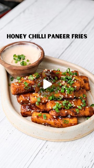 Mahima Dhoot on Instagram: "Honey Chilli Paneer Fries

Fries that are spicing up my Indo-Chinese food obsession 🌶️🍟 Tangy, crispy, and absolutely mind-blowing. It’s like a flavor explosion in every bite, and I’m so here for it. For someone who can’t get enough of Indo-Chinese flavors, this is next-level delicious! 🍜✨

Recipe: 
-cut the 150g paneer into long fries as shown in the video
-take 2 tbsp corn flour in a bowl, add some salt and coat the panner fries in it nicely, and fry them. (You can also air fry or pan fry) 
-for the sauce, add 1 tsp oil, 2 garlic cloves grated, 1 tbsp soy sauce, 2 tbsp chilli sauce (I used sriracha) and 1 tsp honey in a pan & mix it 
-toast your panner in the sauce, coat it well and serve it hot with some spring onions & sesame seeds on top

Dining With Dho Chilli Paneer Recipe Video, Long Fries, Chilli Paneer, Pan Fry, Chilli Recipes, Corn Flour, Spring Onions, Paneer Recipes, Chilli Sauce