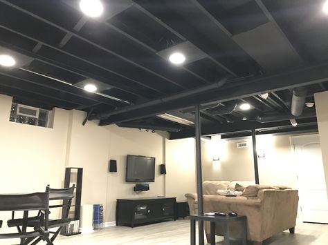 Exposed basement ceiling painted black. Plywood added around recessed lights for a more finished look. Single HVAC duct left unpainted. Black Basement Ceiling, Basement Ceiling Ideas Cheap, Unfinished Basement Ceiling, Exposed Basement Ceiling, Basement Ceiling Painted, Basement Ceiling Options, Low Ceiling Basement, Basement Lighting, Basement Layout