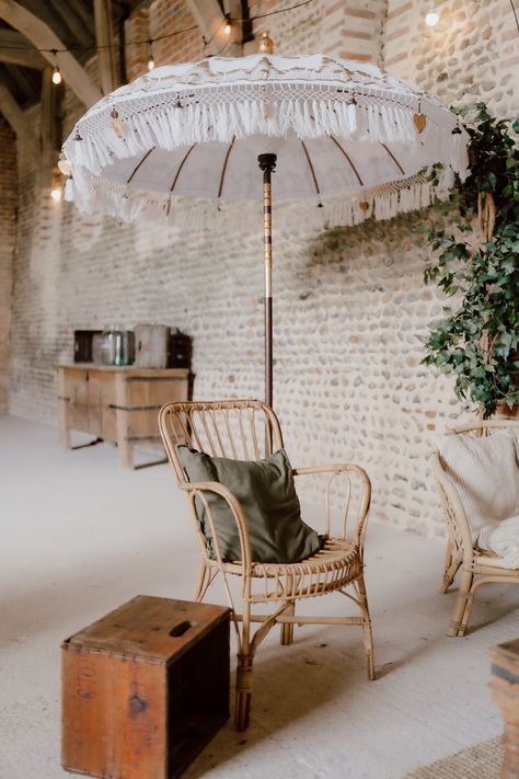 This shows a barn seating area for a wedding. The focus is on a cane chair paired with a olive green cushion and a white Balinese parasol. Next to this is a natural evergreen tree. Bali Umbrella, Event Lounge, Decorative Umbrella, Tree Props, Patio Umbrella Covers, Peacock Chairs, Natural Vibes, Boho Lounge, Barn Photography