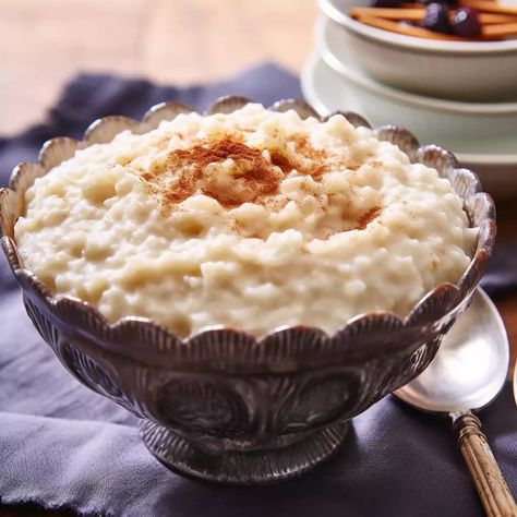 Rice Pudding, this seemingly simple dessert, is an embodiment of comfort, love, and tradition wrapped into a creamy and flavourful dish. From the first bite, it transports me back to my childhood days when I would sit in my grandmother’s kitchen, waiting for that delightful bowl of warm, sweet pudding.  Originating from Asia, where rice […] The post Rice Pudding appeared first on Cook with Nabeela. Rice Pudding Photography, Creamy Rice Pudding, Rice Pudding Recipe, Simple Dessert, Classic Cheesecake, Refreshing Desserts, Childhood Days, Rice Pudding, British Food