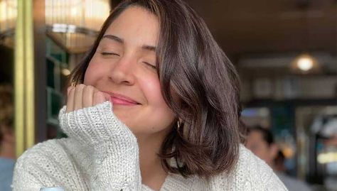 Anushka Sharma has shared a sun-kissed photo of herself on Instagram. The new photo has the actor sporting a new short haircut with a beautiful smile on her face. The picture is from her recent lunch date with her husband Virat Kohli. Anushka is wearing a white woolen sweater, she looks radiant with an unmissable glow on her face. While her eyes are closed in the photo, presumably taken by Virat, she beams at the camera. Posting the picture, she added a white flower emoji to it. Recently, pictur New Short Haircuts, Dear Daughter, Anushka Sharma, Bright Smile, Virat Kohli, Hair Color Balayage, Bollywood Celebrities, Beautiful Smile, Natural Hair Care